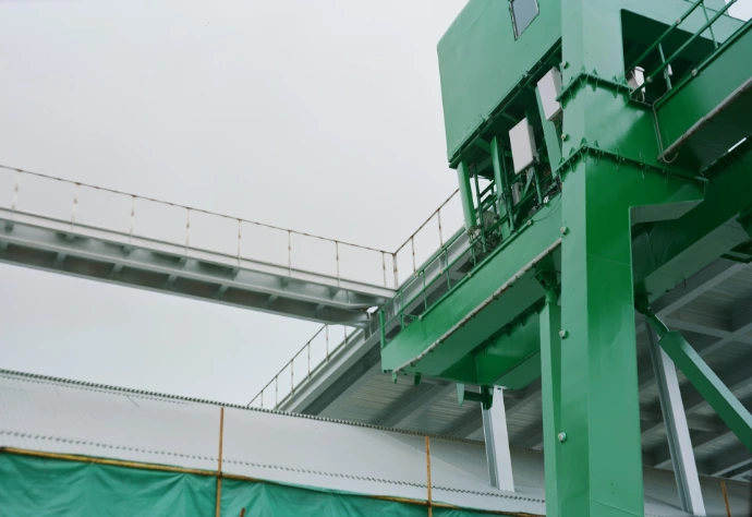 a tall green building with a sky background